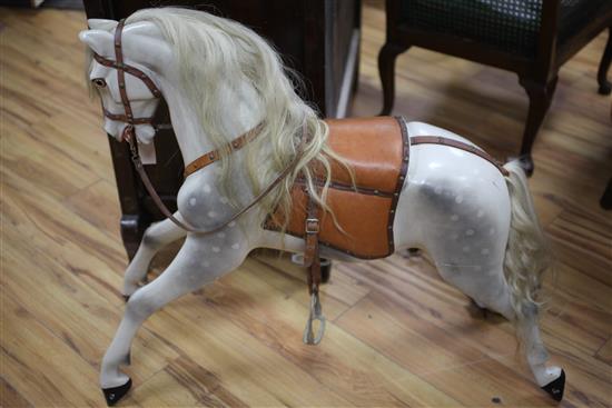 A dapple grey painted carved wood rocking horse, length 40in.